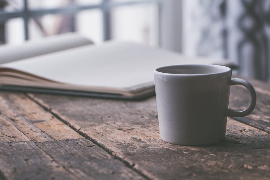 journaling practice on a table with a coffee mug